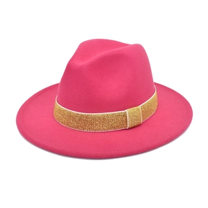 Detailed view of fuchsia wool fedora with a shimmering gold sequin decorative hat band