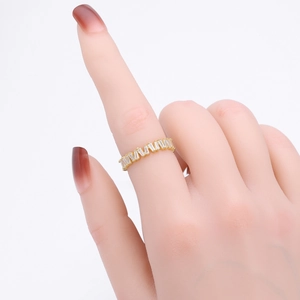 Close-up of gold V-shaped ring with rectangular zircon stones on hand model