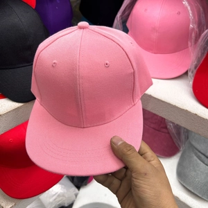 Detailed view of pink cotton flat brim baseball cap with twill texture and eyelets