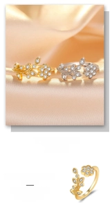 Detail of floral hollow open ring with sparkling zirconia in gold and silver plating
