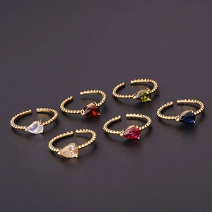 Six-color adjustable teardrop zircon rings with gold beaded band on black background