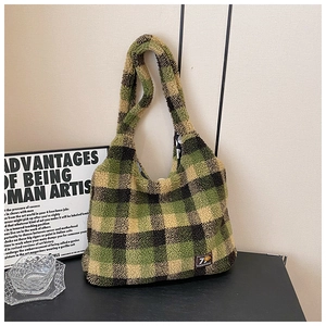 Close-up of green checkered plush tote bag with vintage texture and brand patch