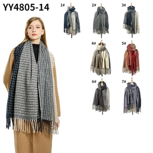 Detail showcasing seven color options for plaid scarves with long tassels and soft texture