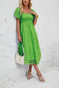 Detailed emerald green maxi dress with puff sleeves and textured checkered fabric