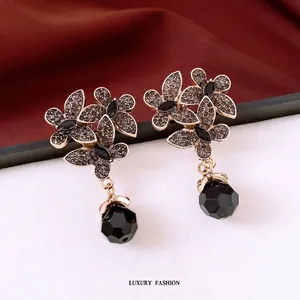 Vintage floral drop earrings with black faceted crystals and pavé diamonds on velvet
