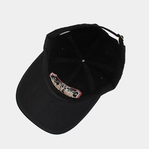 Black cotton baseball cap showing internal sweatband and adjustable metal buckle closure