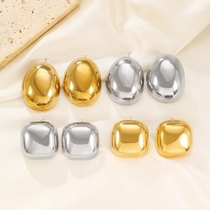 Detailed view of polished oval and square stainless steel earrings in gold and silver