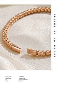 Detail of rose gold beaded bracelet with secure clasp on elegant silk fabric background