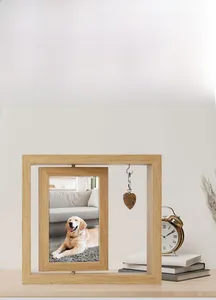 Close-up of rotating wooden photo frame with a heart pendant and a golden retriever picture