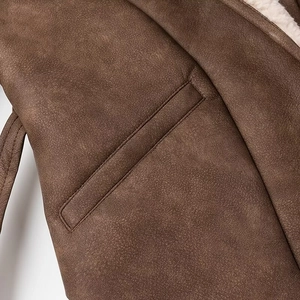 Close-up of brown faux leather jacket featuring plush sherpa lining and pocket detail
