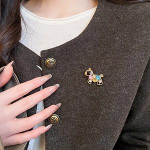 Close-up of a luxurious horse brooch with colorful crystals pinned on a dark wool coat