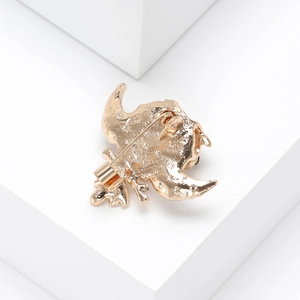 Detailed back view of a gold metal animal brooch showing the secure pin closure and texture