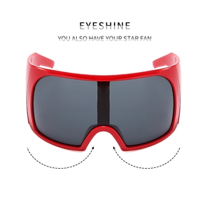 Close-up of futuristic red wrap-around frame sunglasses with large grey shield lens