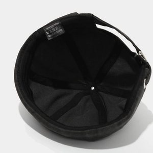Internal view of black cotton docker hat with reinforced seams and adjustable strap