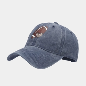 Detail of vintage washed cotton baseball cap featuring rugby and leopard heart print