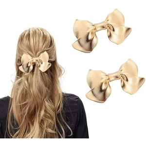 Elegant gold metallic bow hair clip featuring a brushed texture for women in gold finish