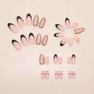 Detailed close-up of almond-shaped press-on nails with gold borders and micro diamonds