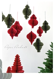 Close-up of red and dark green honeycomb paper pendants for Christmas decoration