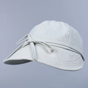 Detail of light grey nylon sun hat featuring sweet bow tie ribbon and reinforced stitching