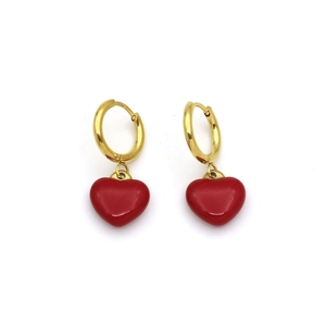 Detailed view of elegant gold hoop earrings with vibrant red heart-shaped pendants