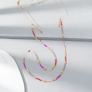Macro shot of colorful crystal beads eyewear chain with golden heart accents