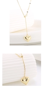 Macro shot of 3D gold heart pendant with mirror polish and adjustable slider chain