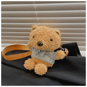 Close-up of plush teddy bear crossbody bag wearing a grey sweater with pearl bow