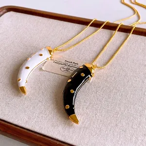 Ethnic style horn pendant necklaces with black and white enamel and golden studs