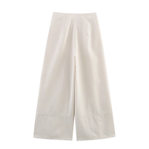 Detail view of cream wide-leg linen trousers with high waist and hem stitch accents