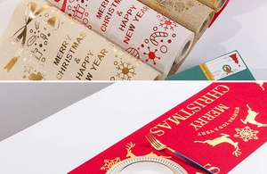 Detail of Christmas table runner featuring gold foil reindeer and festive linen patterns