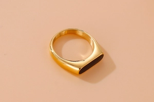 Detail view of a vintage gold titanium steel ring featuring a black rectangular resin inlay