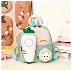 Detail of mint green toddler backpack featuring a 3D carrot pocket and rabbit print