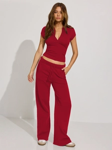 Detail view of red V-neck Henley top and matching wide-leg drawstring pants set