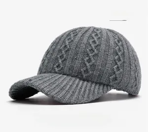 Detail of grey cable knit baseball cap with thick textured wool blend fabric