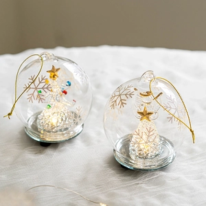 Luminous glass Christmas angel ball with warm LED lights and golden star details