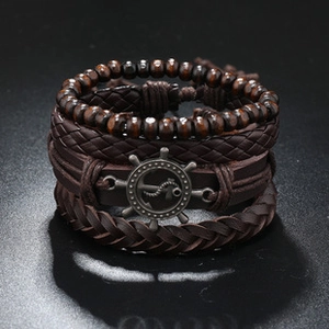 Detail of multi-layer leather bracelet set with wooden beads and nautical anchor charm