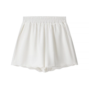 Close-up of white high-waisted shorts featuring elastic waist and petal-shaped hemline