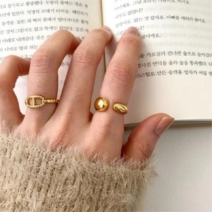 Detail of 925 sterling silver golden drop ring and chain ring worn on hand