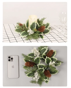 Detailed view of Christmas candle ring with pine cones and berries beside iPhone for scale