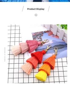 Detailed macro view of triple-tiered gradient cotton tassels with gold lobster clasps