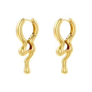 Close-up of golden liquid metal hoop earrings with an irregular melt texture design