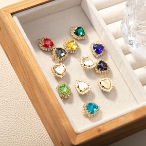 Exquisite heart-shaped gemstone pendants with diamond-set edges in a luxury wooden jewelry box