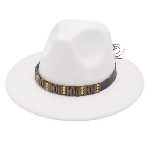 Detail of white fedora hat featuring brown leather band with shells and metal accents