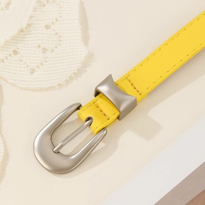 Minimalist yellow vintage leather belt with matte silver buckle and precision stitching