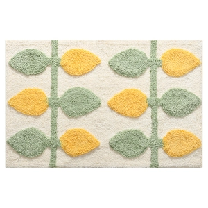 Absorbent bathroom mat with yellow and green leaf pattern in thick tufted fabric