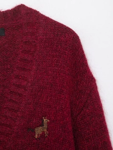Detail of burgundy mohair knit cardigan featuring a beaded giraffe embroidery patch