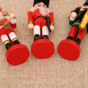 Detail of wooden Nutcracker soldier base on linen background for Christmas decor