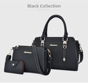 Detailed view of 3-piece black pebble leather handbag set with gold-tone hardware