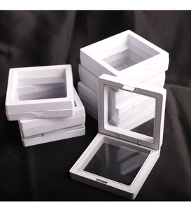 Macro view of white square PE film jewelry display cases with push-to-open latch detail