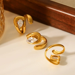 Golden stainless steel open rings featuring pear-cut zircon stones in a minimalist design